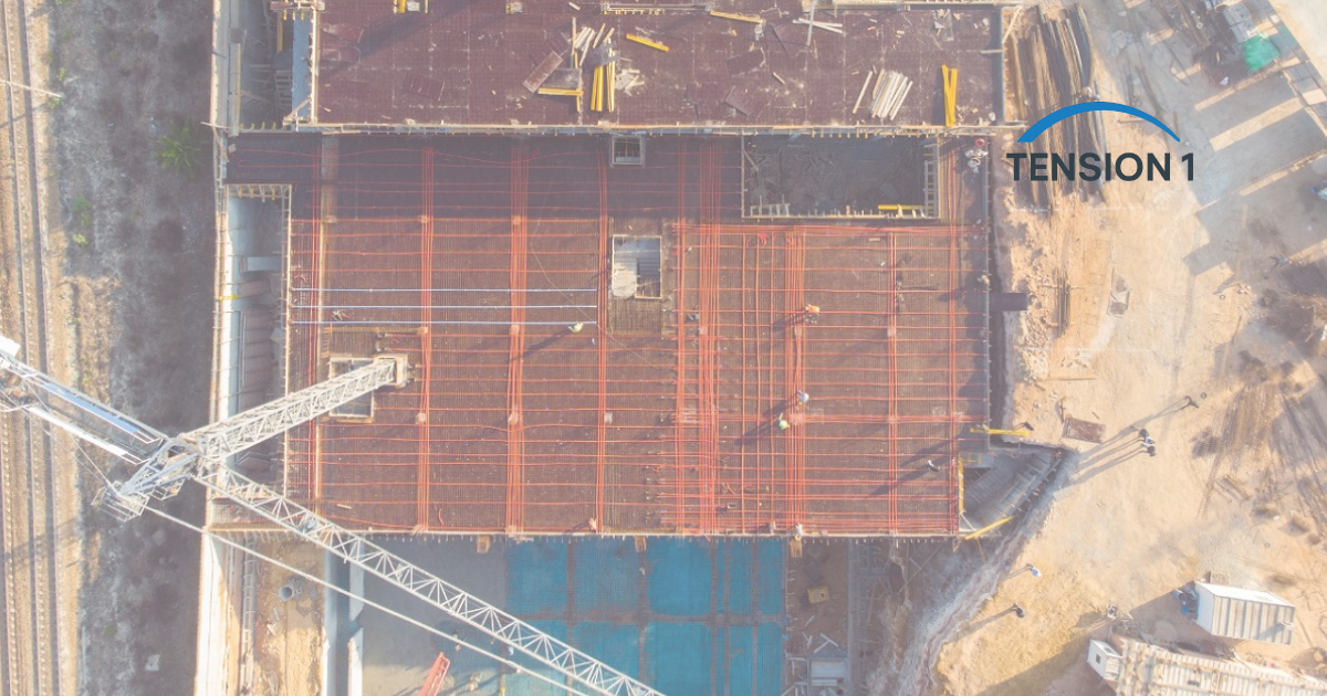 Aerial view of a post tension slab construction site showing the installation of tendons and rebar grid before concrete pouring.